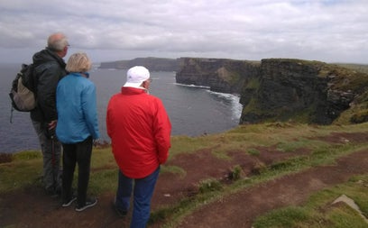 Group of three people looking at coast