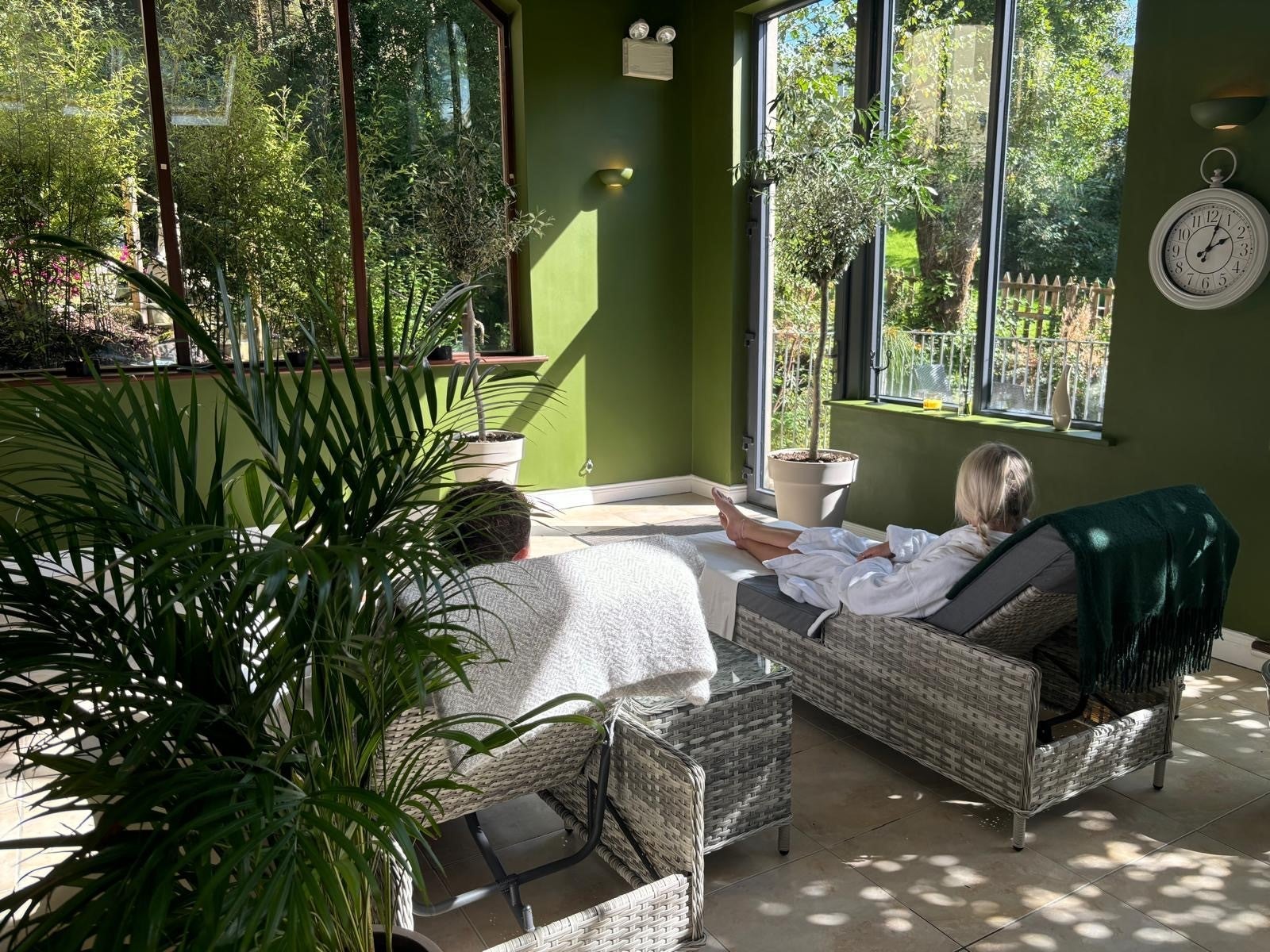Two people lying on wicker lounges in a relaxation room in a spa
