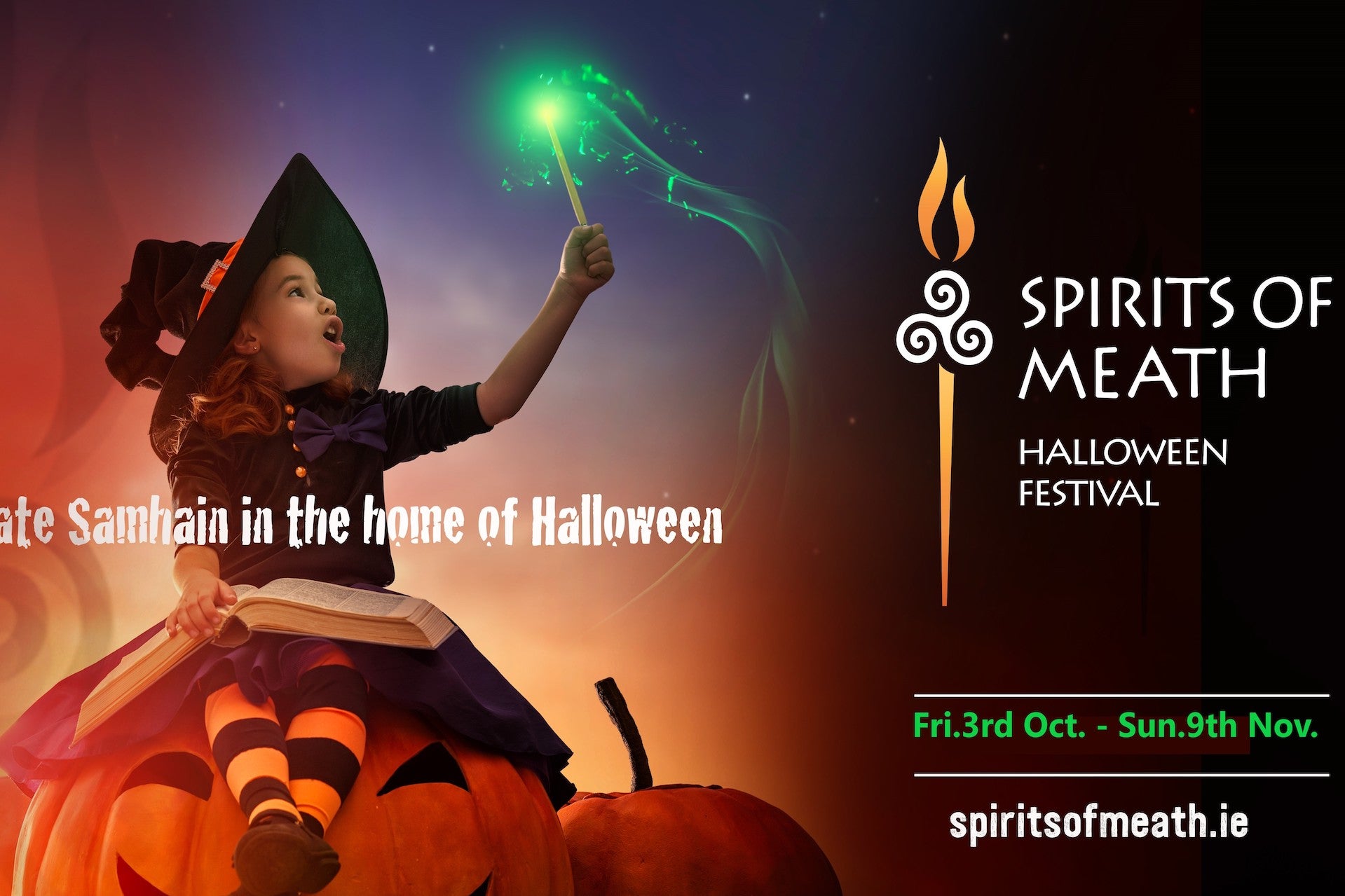 Child in witch's costume sitting on a large pumpkin holding up a wand with a green tip