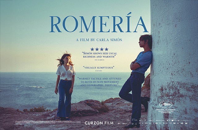 Film poster with 2 people standing on rocky area with sea in the background.