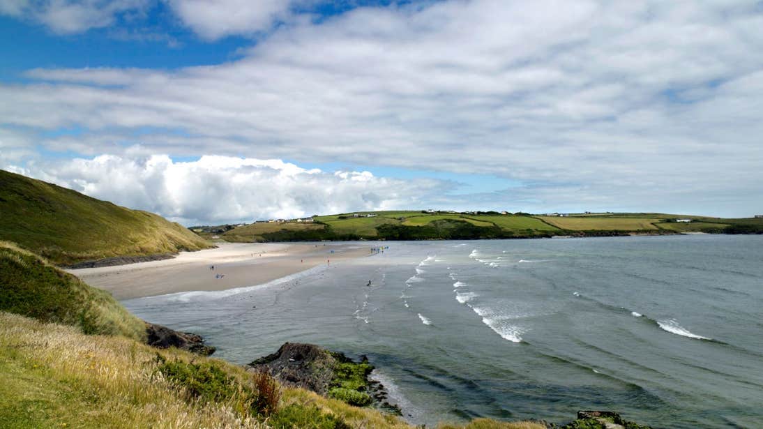 Waves on Inchydoney Beach in West Cork under green hills