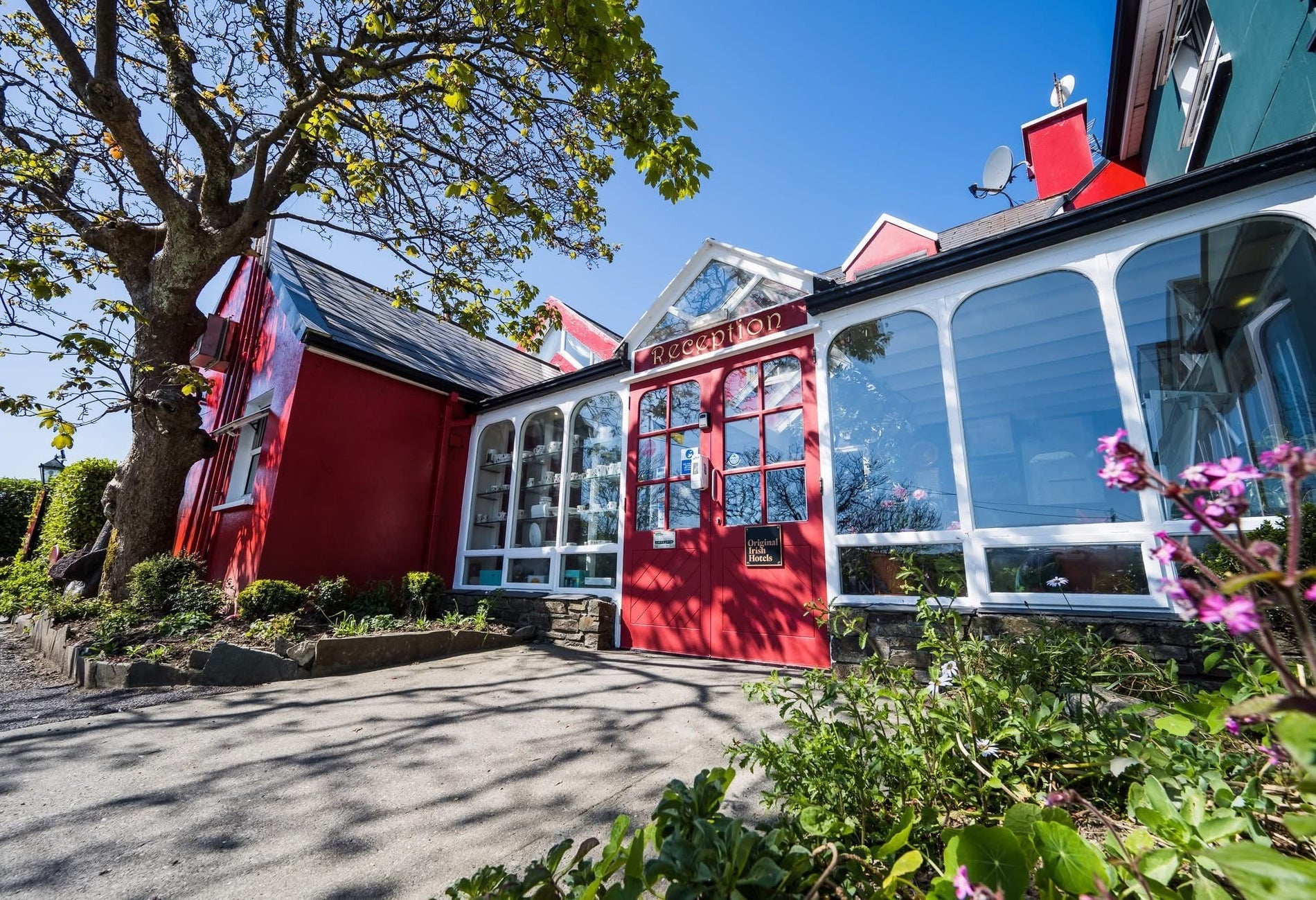The front of a building with large windows and a red front door