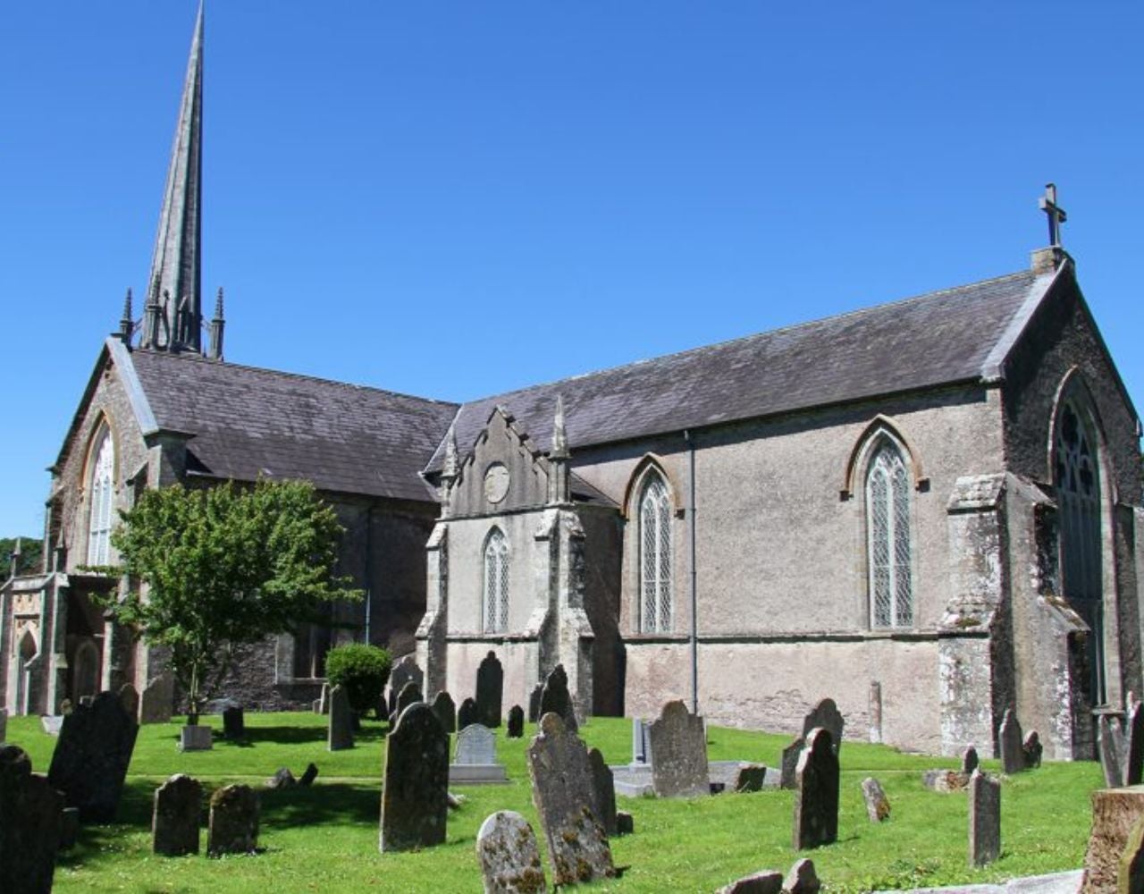 A large church with a cemetery and lots of headstones