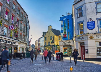 Visitors along the streets of Galway with colourful shopfronts