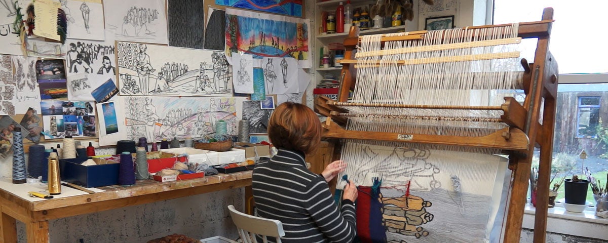 Frances Crowe weaving a tapestry at her Dryad loom