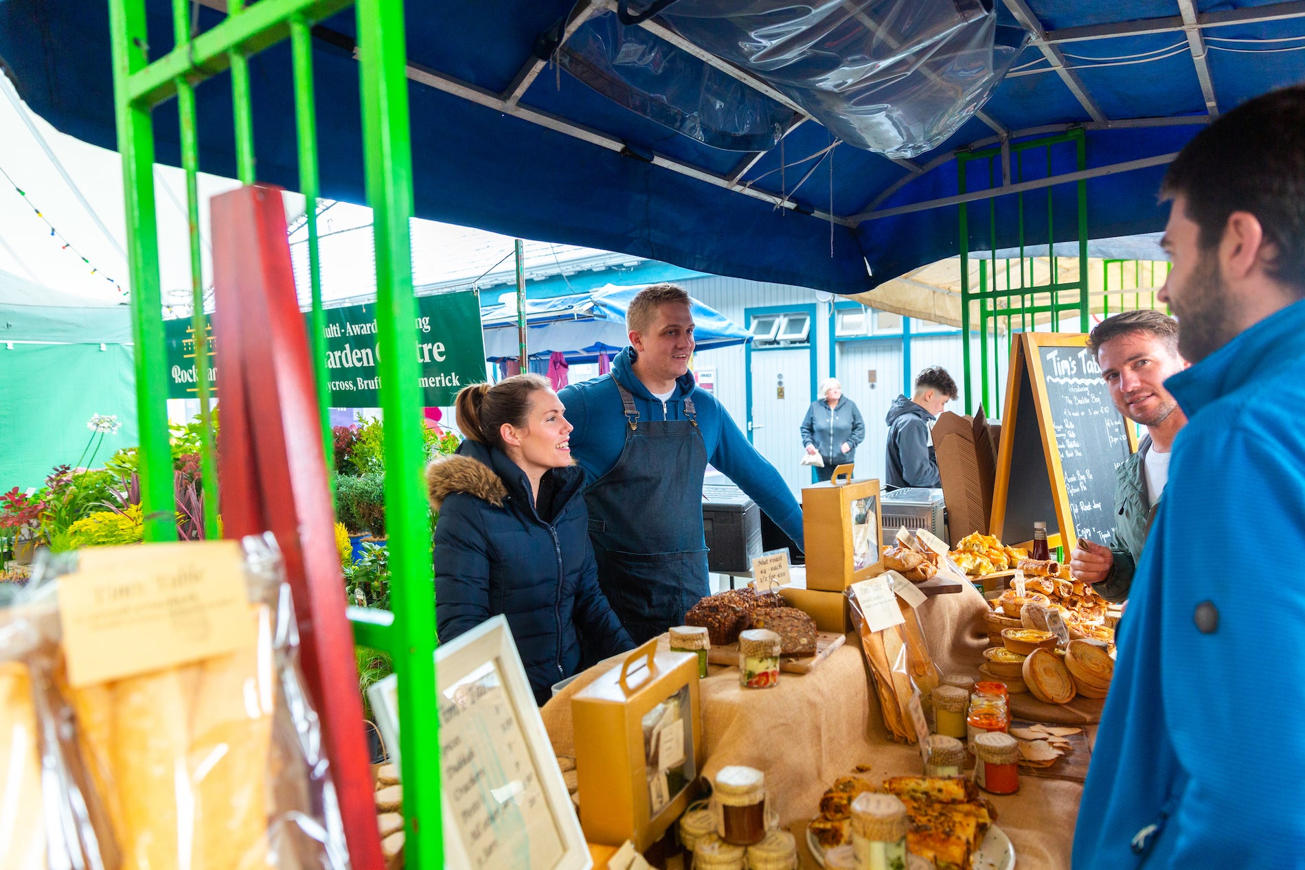 Two merchants serving customers at the Milk Market in Limerick.