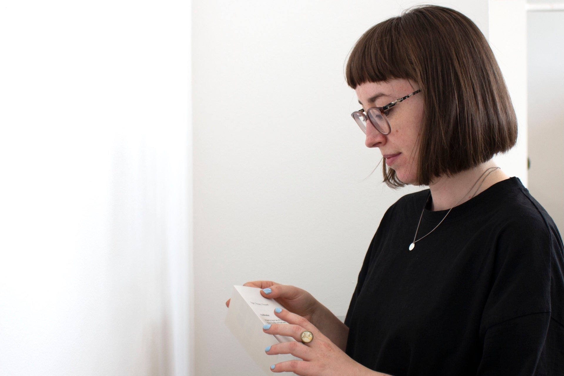 Kim Crowley looking at a book she's holding