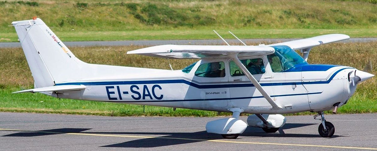 White Cessna airplane on tarmac