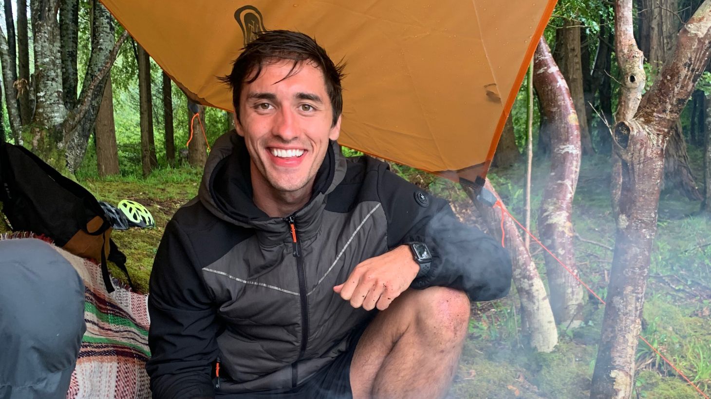 Greg O'Shea sitting under a yellow shelter in a forest in Sligo