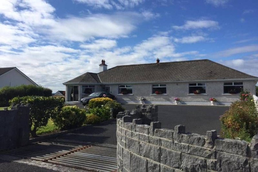 Front view of house and garden.