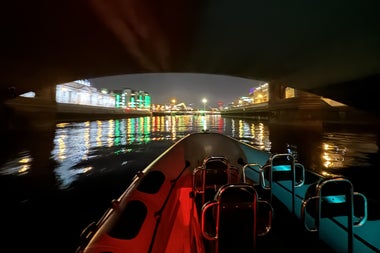A view of the Customs house at night from a RIB under a bridge on the River Liffey