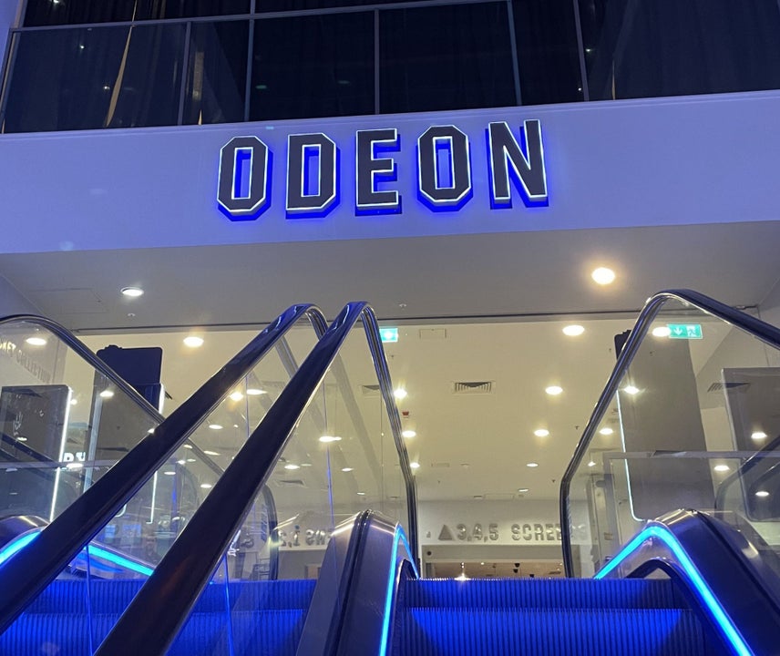 An Odeon sign at the top of an escalator