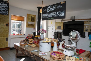 A café counter with lots of items displayed on it