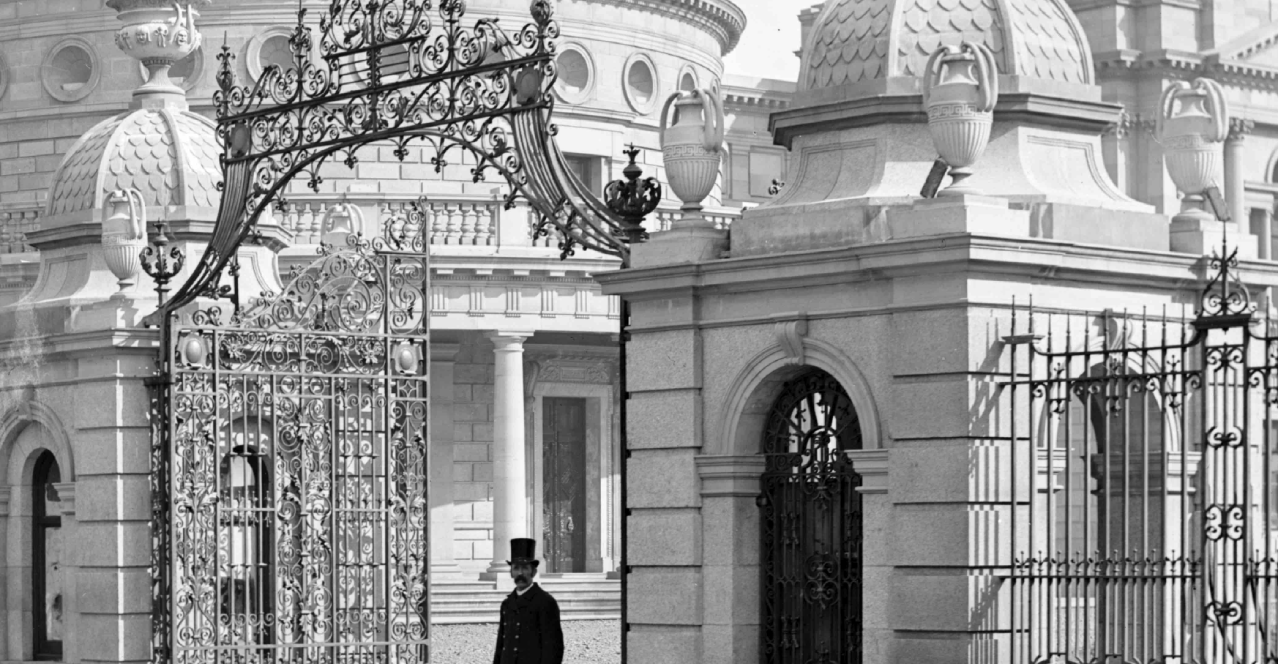 Cut & Paste No. 9 2026: Remembering Arthur Griffith, old black and white photo of gentleman walking through ornate iron gates from a Georgian building.
