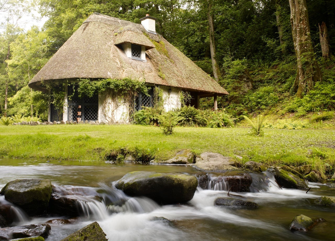 A thatched cottage beside a river