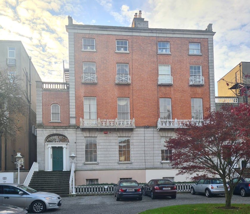 Two storey red bricked building on a city street