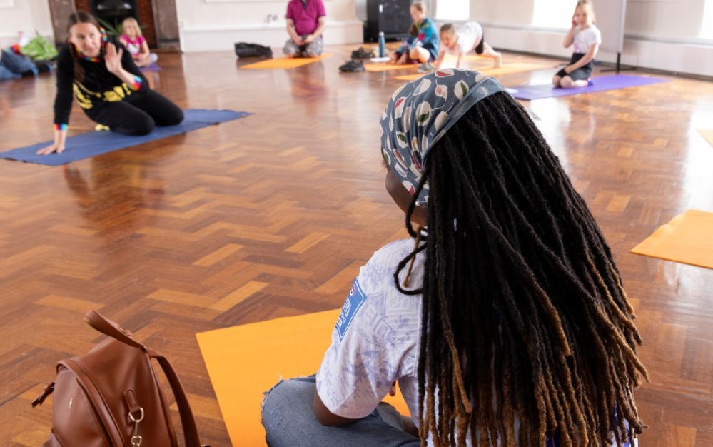 A photo of woman doing yoga in Museum