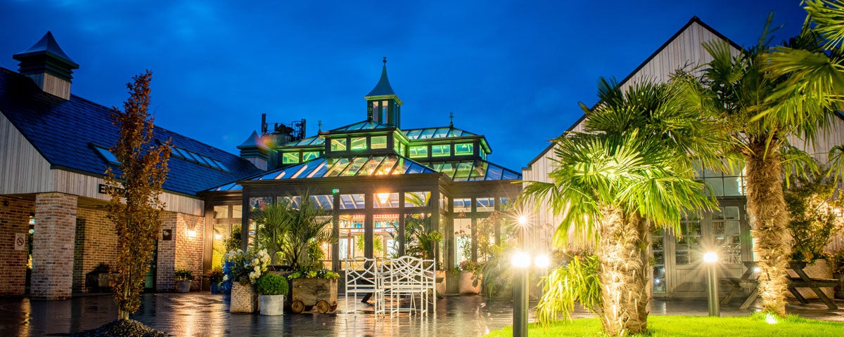 The exterior of The Shed Distillery lit up at night