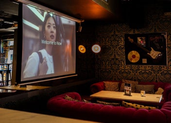 Comfortable seating area in a bar with a table and a menu on display