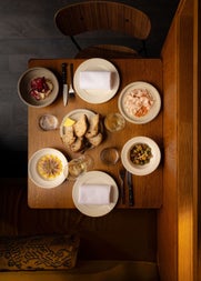 View looking down over a table full of dishes from the menu at Comet