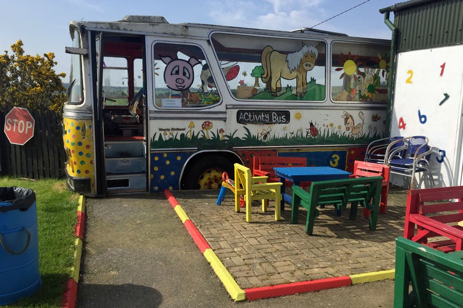 View of activity bus and patio area at Tick Tock Farm