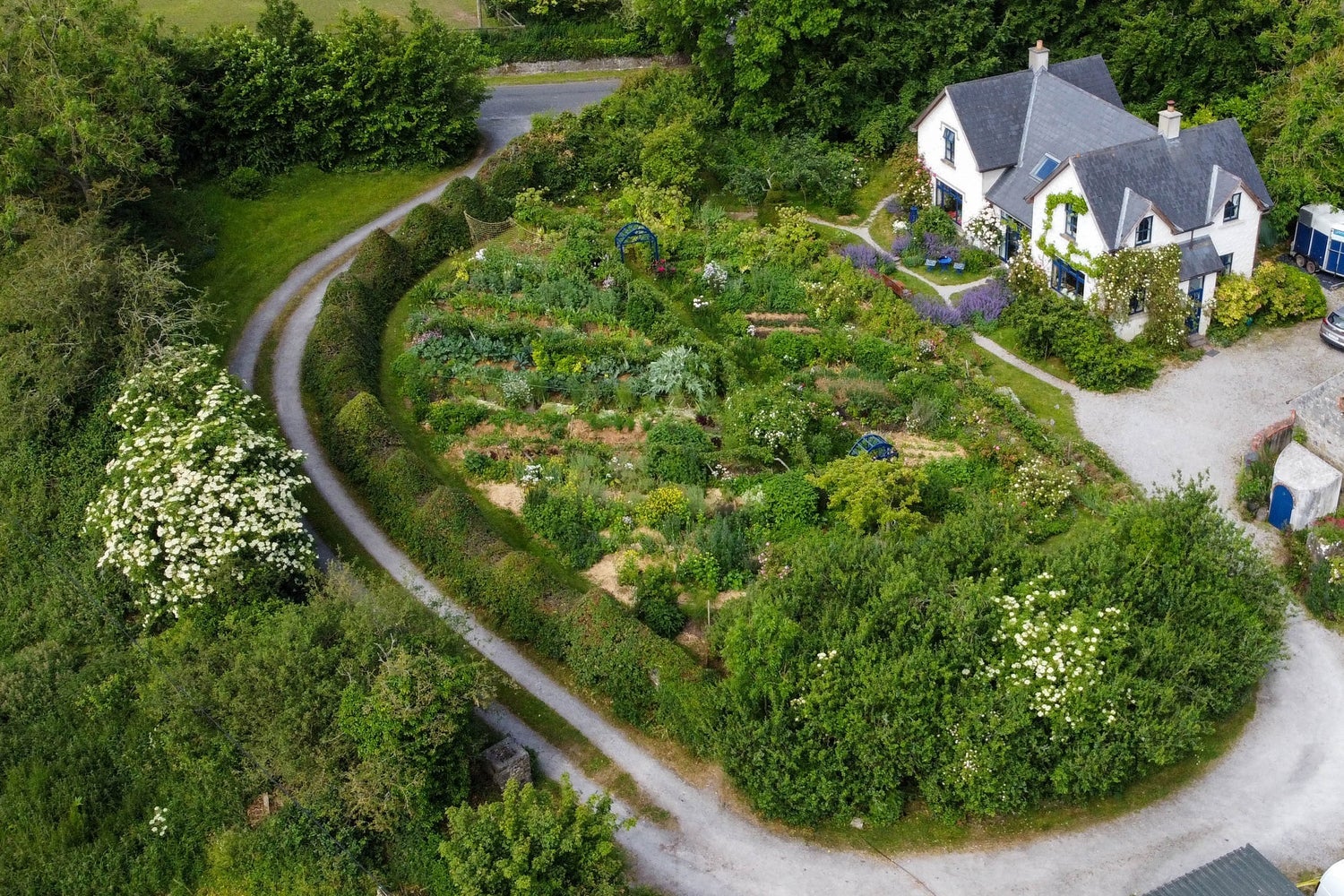 An aerial view of a house with a substantial garden