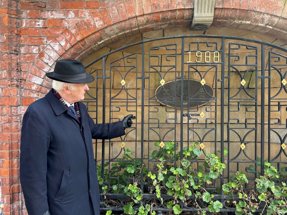 Tour guide Pat Liddy pauses beside an ornate iron gate and bronze plaque commemorating Jonathan Swift as he shares the stories behind the Dublin city's storied streets.