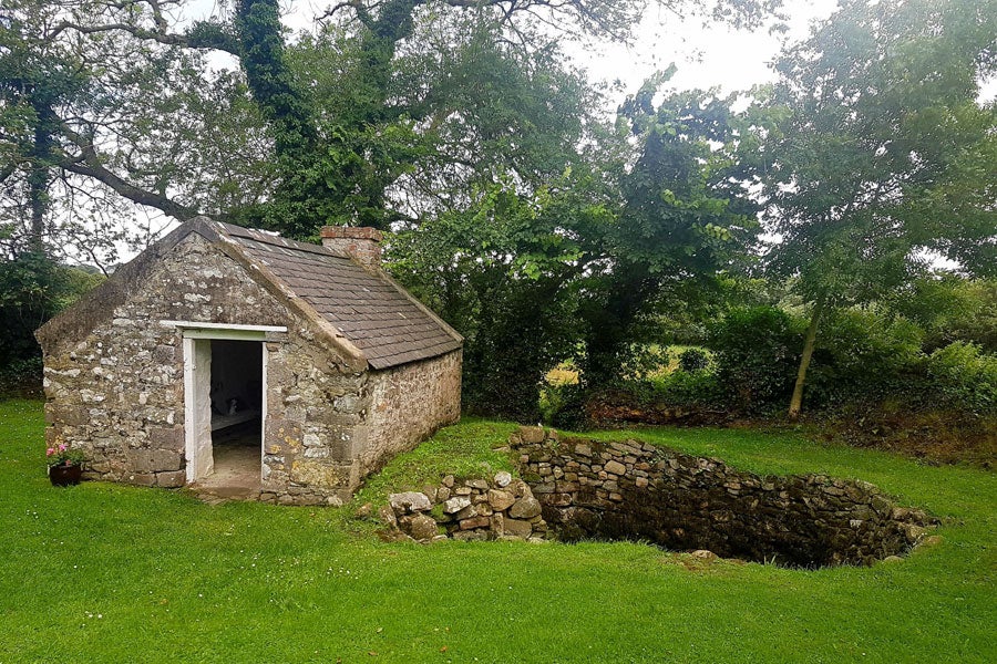 A view of the Tobar Na Molt holy well and nearby shelter building
