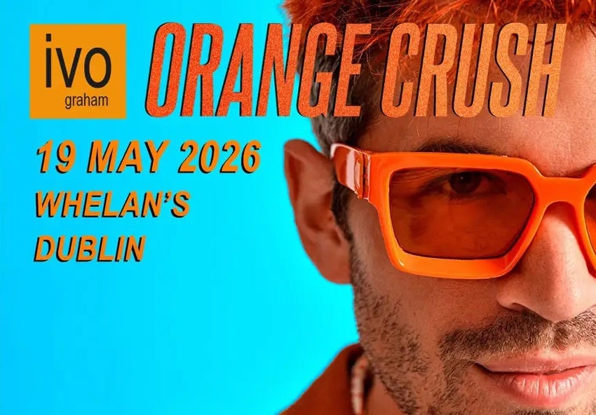 Close up view of right side only of a man's face wearing orange sunglasses