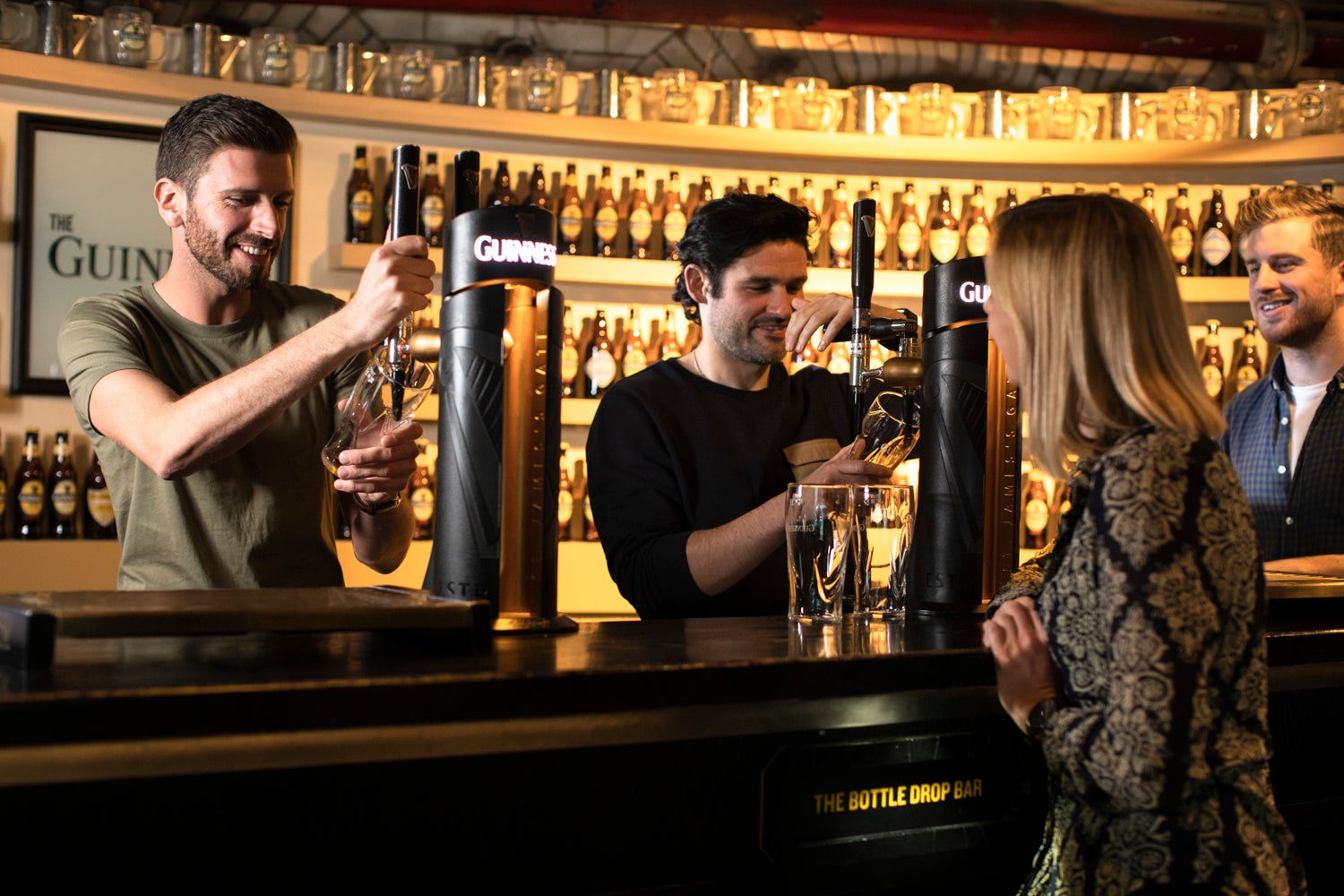 People pulling pints at the Guinness Storehouse in Dublin city