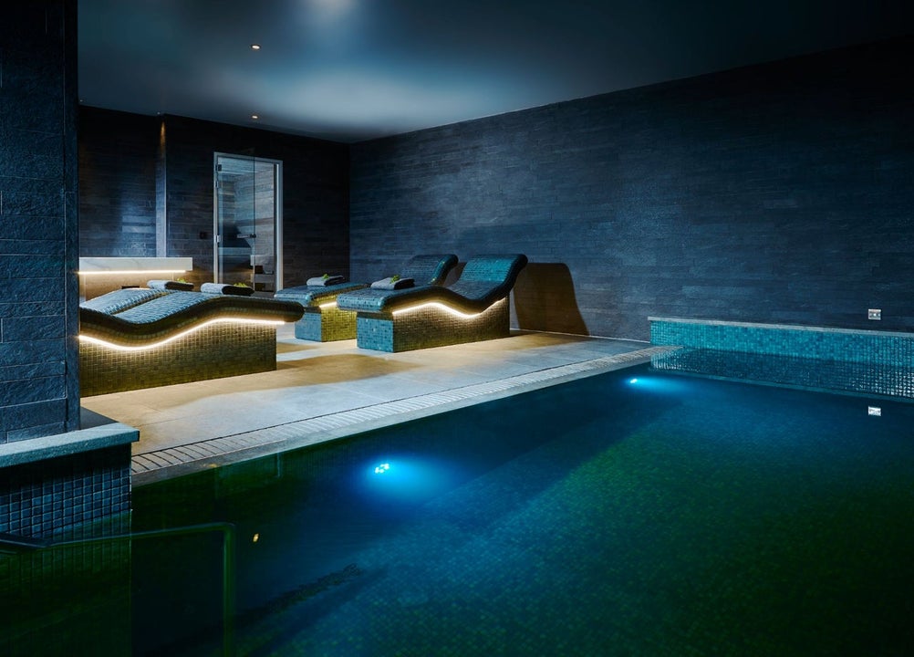 A relaxation pool with underwater lighting with heated loungers