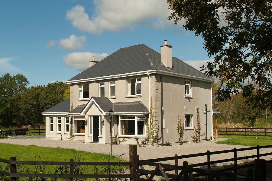 Exterior of house with garden enclosed by timber fence
