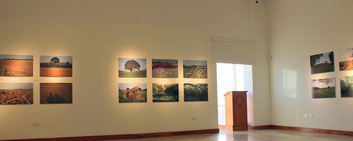 View of gallery with paintings displayed on the walls