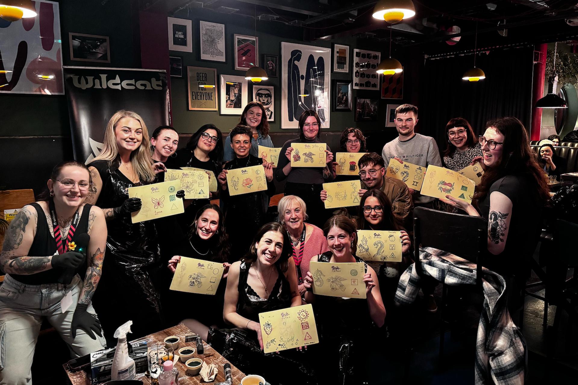 A buzzing group of guests proudly showing off their tattoo “masterpieces” on practice skin. Big smiles, good vibes, and the perfect snapshot of Dublin’s wildest, most creative night out.