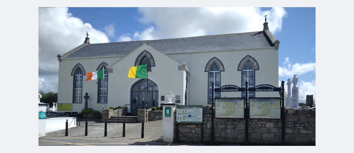 Exterior of a tourist office with flags flying outside