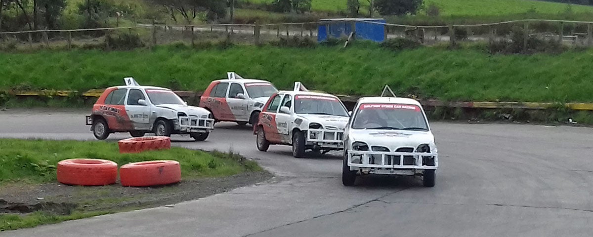 Image of four stockcars racing around bend
