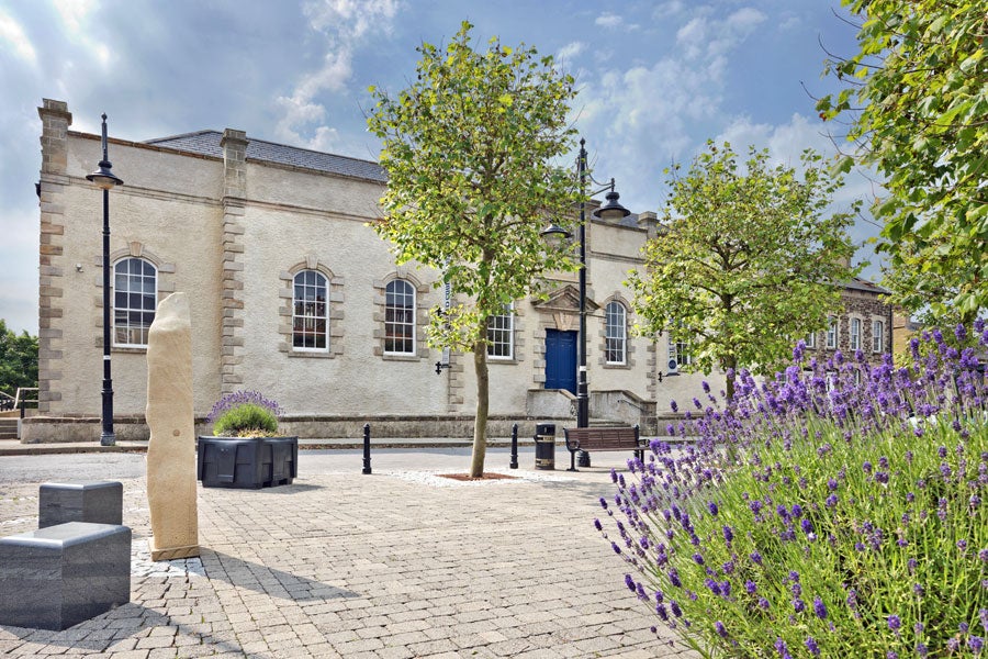 View of Lifford Old Courthouse with trees and shrubs in front