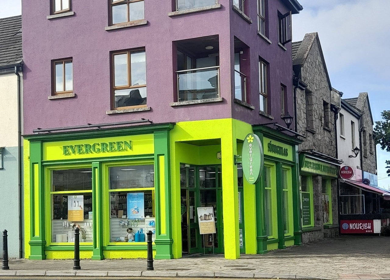 The green and yellow exterior of a health food shop