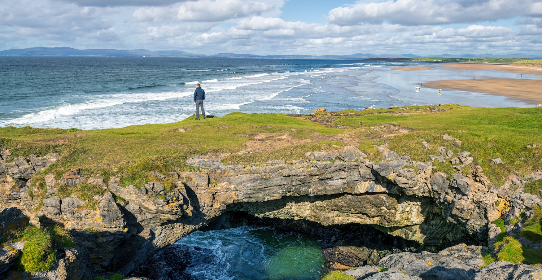 A man standing on the Fairy Bridges in Bundoran, County Donegal