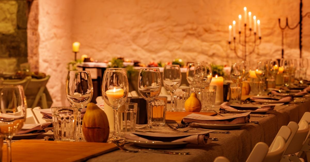 Firelit courtyard with medieval-inspired cocktails, setting the mood for a vibrant, interactive long-table feast.