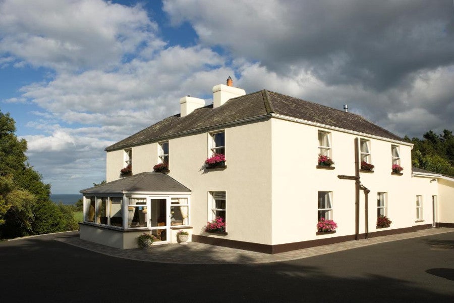Cream house with pink window boxes