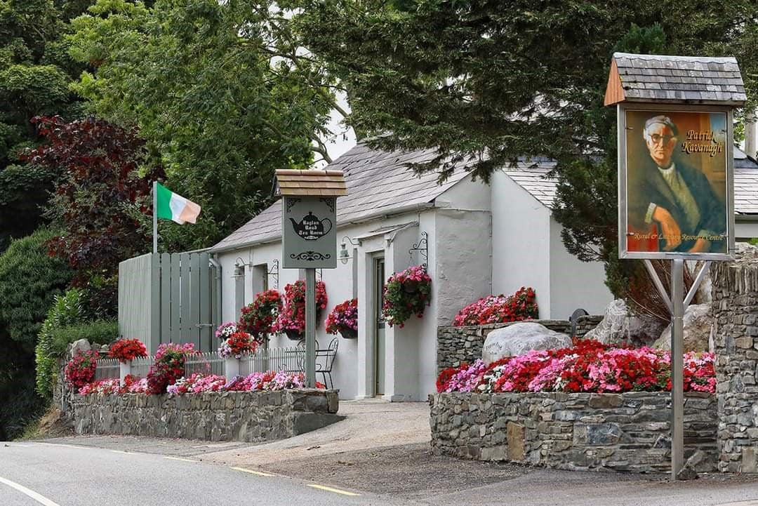 Exterior of a tearoom with stone walls and colourful flowers