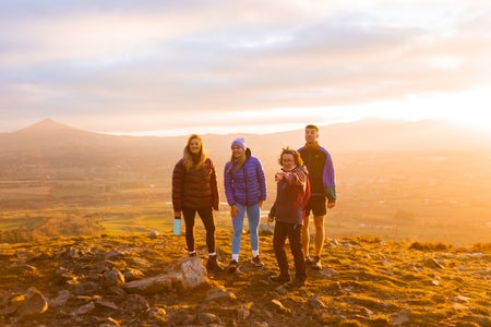Group of walkers and guide at sunset, Hilltoptrek, Dublin