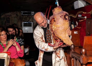 A tour guide holding a gruesome prop