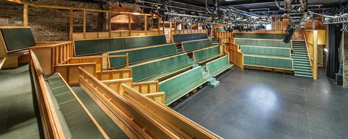 Tiered seats facing a stage in a theatre