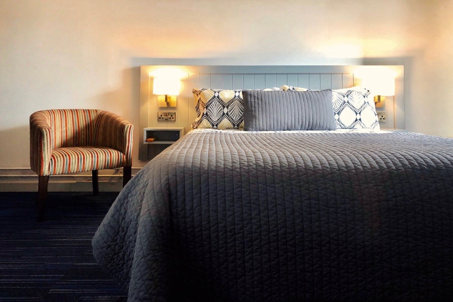 double bedroom with bedside chair