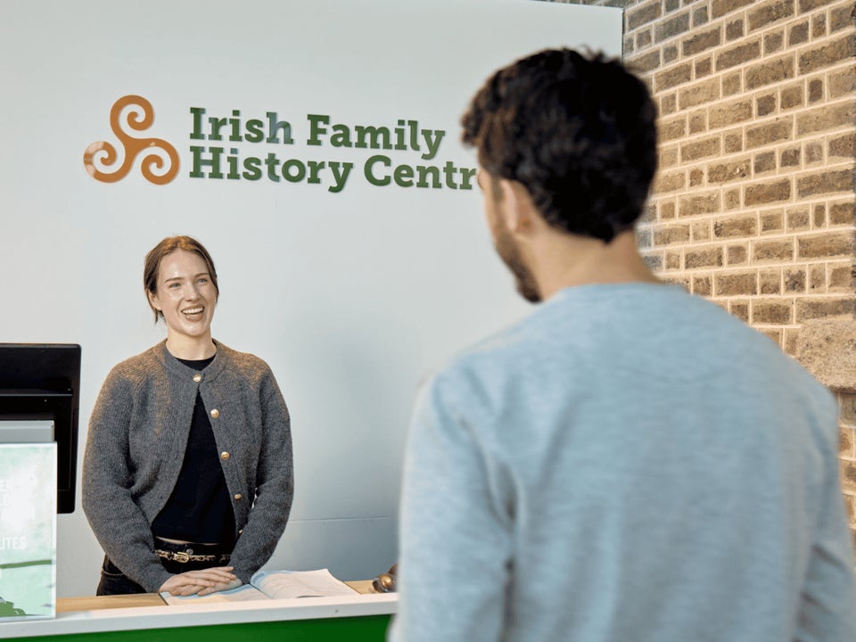 A visitor arrives for a genealogy consultation at the Irish Family History Centre, located at EPIC The Irish Emigration Museum in Dublin's Docklands. Expert guidance helps visitors explore their Irish ancestry.
