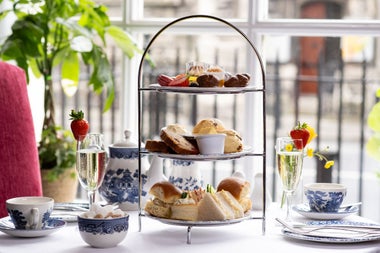 An afternoon tea setting with glasses of prosecco