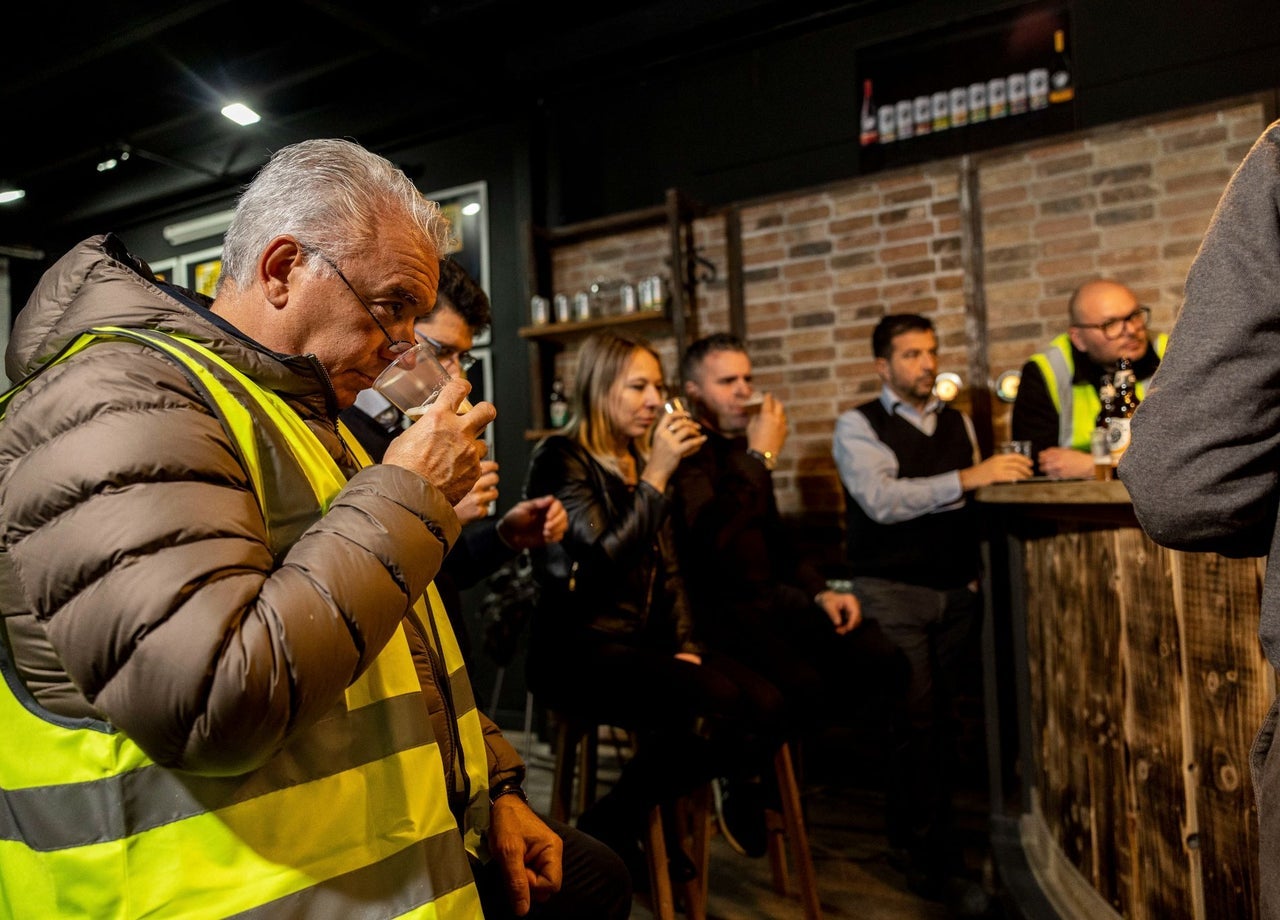 People in a tasting room sampling beer