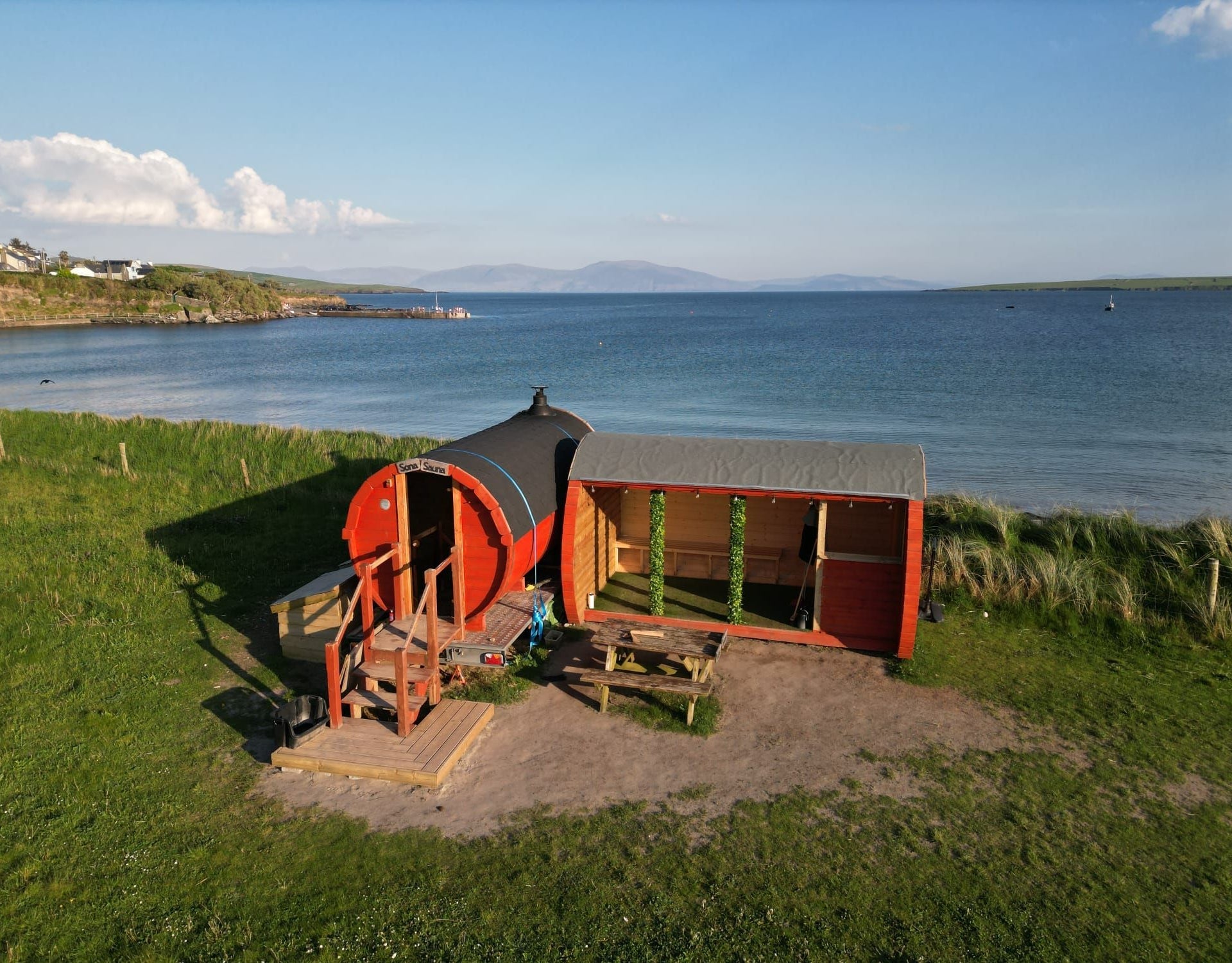 Sona Sauna at Ventry Beach with Ventry village and the sea in the background